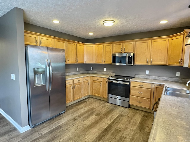 222 Sinclair Dr, West Lafayette, IN 47906 - kitchen featuring appliances with stainless steel finishes, light wood-style floors, light countertops, a textured ceiling, and recessed lighting