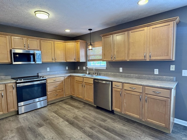 222 Sinclair Dr, West Lafayette, IN 47906 - kitchen featuring stainless steel appliances, wood finished floors, hanging light fixtures, a textured ceiling, and light countertops