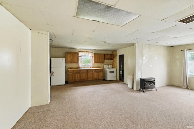 512 E Pike St, Kirklin, IN 46050 - kitchen with white appliances, brown cabinets, light carpet, light countertops, and under cabinet range hood