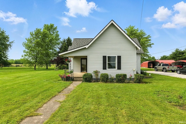 512 E Pike St, Kirklin, IN 46050 - bungalow-style home featuring a porch, a shingled roof, and a front yard