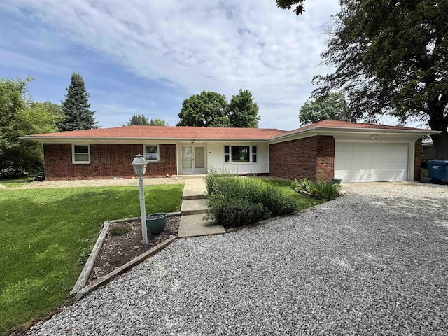 1635 Liberty St, Covington, IN 47932 - single story home with driveway, a garage, a front yard, and brick siding