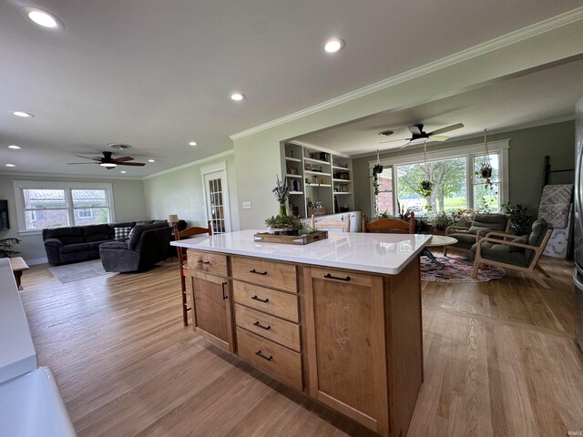 1635 Liberty St, Covington, IN 47932 - kitchen with open floor plan, a ceiling fan, light wood-style floors, recessed lighting, and ornamental molding