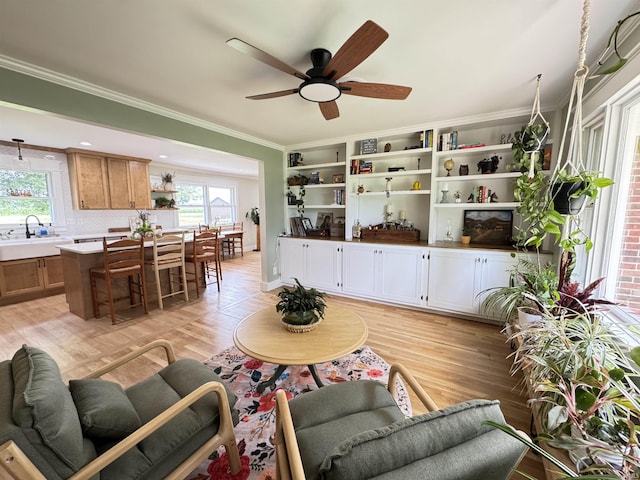 1635 Liberty St, Covington, IN 47932 - living area featuring plenty of natural light, light wood-type flooring, a ceiling fan, and crown molding