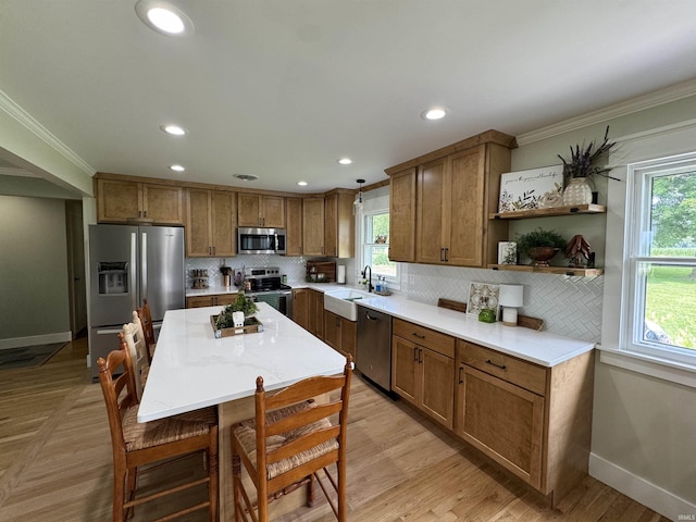 1635 Liberty St, Covington, IN 47932 - kitchen with appliances with stainless steel finishes, brown cabinetry, healthy amount of natural light, backsplash, and recessed lighting