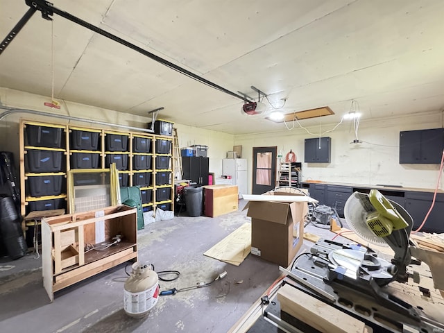 1635 Liberty St, Covington, IN 47932 - garage featuring freestanding refrigerator and a garage door opener