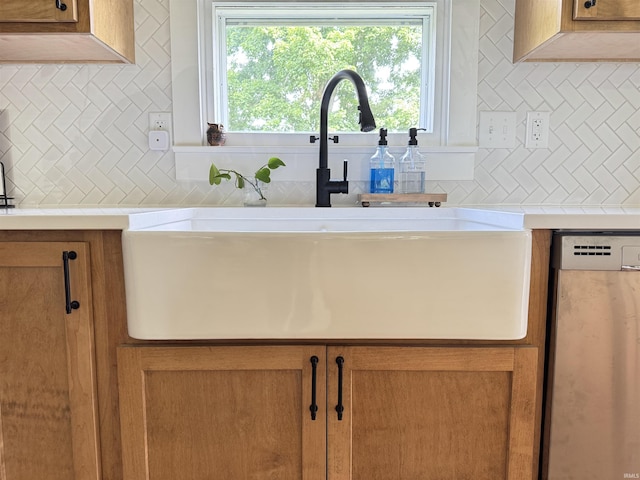 1635 Liberty St, Covington, IN 47932 - kitchen view of dishwashing machine, tasteful backsplash, light countertops, and brown cabinetry