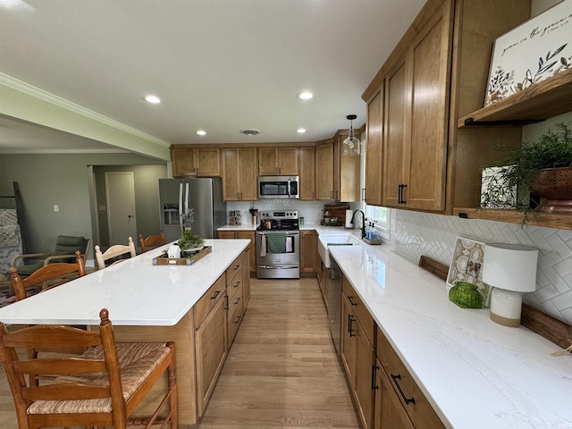 1635 Liberty St, Covington, IN 47932 - kitchen featuring stainless steel appliances, brown cabinetry, a kitchen breakfast bar, backsplash, and a center island