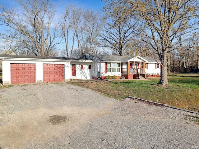 485 Boone St, New Haven, IL 62867 - view of front facade featuring dirt driveway, a front lawn, an attached garage, and covered porch
