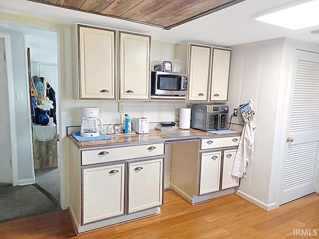 485 Boone St, New Haven, IL 62867 - kitchen with stainless steel microwave, light wood-type flooring, and light countertops