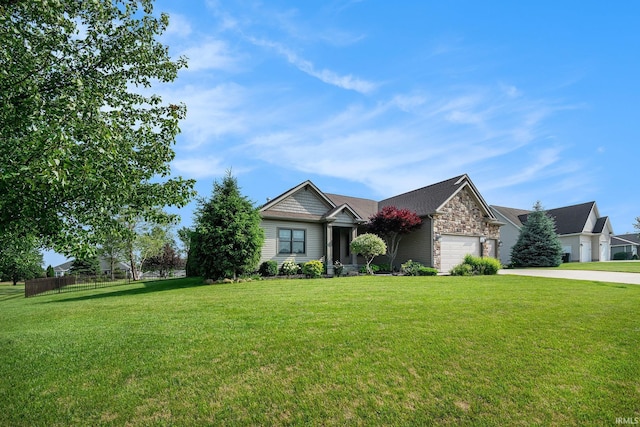 645 E Essex Dr, Warsaw, IN 46582 - view of front of property featuring a garage, concrete driveway, and stone siding