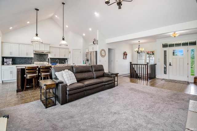 645 E Essex Dr, Warsaw, IN 46582 - living area featuring a chandelier, light tile patterned flooring, high vaulted ceiling, recessed lighting, and light carpet