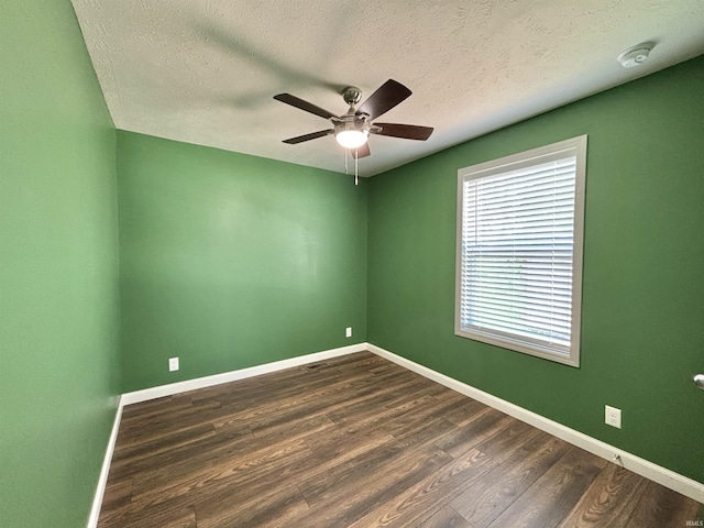 215 N Jefferson St, Lyons, IN 47443 - unfurnished room with ceiling fan, dark wood finished floors, a textured ceiling, and a smoke detector