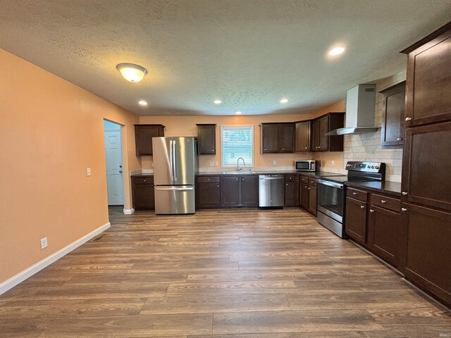 215 N Jefferson St, Lyons, IN 47443 - kitchen featuring stainless steel appliances, wall chimney range hood, dark wood-type flooring, dark brown cabinets, and recessed lighting