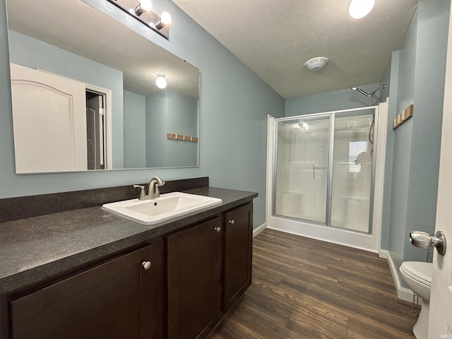 215 N Jefferson St, Lyons, IN 47443 - full bathroom with a shower stall, vanity, wood finished floors, and a textured ceiling