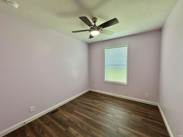 215 N Jefferson St, Lyons, IN 47443 - spare room featuring dark wood-style flooring, a ceiling fan, and a smoke detector