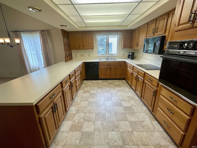 845 Crosspointe Ct, Wabash, IN 46992 - kitchen with black appliances, brown cabinetry, a chandelier, a peninsula, and light countertops