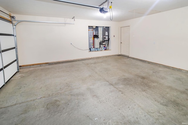 390 Mallard Cir, Chandler, IN 47610 - garage featuring electric water heater and a garage door opener