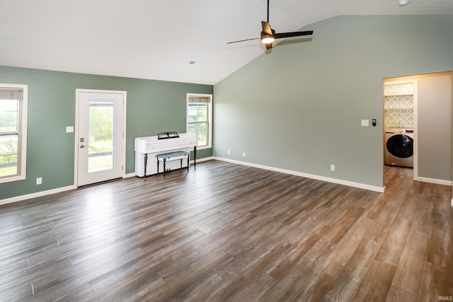 390 Mallard Cir, Chandler, IN 47610 - unfurnished living room featuring washer / dryer, lofted ceiling, dark wood-type flooring, and a ceiling fan