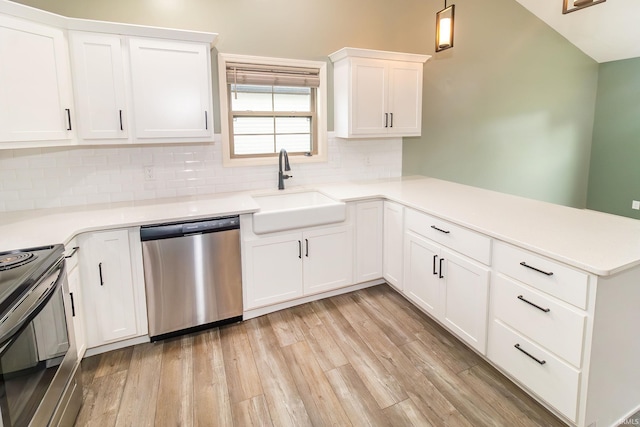 390 Mallard Cir, Chandler, IN 47610 - kitchen with stainless steel appliances, a peninsula, backsplash, and light countertops