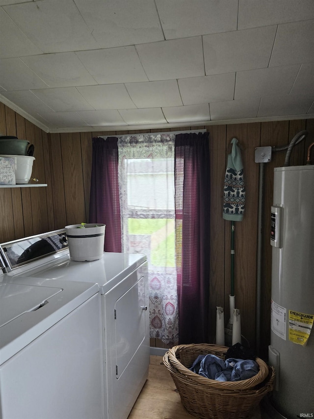 221 W 11th St, Bicknell, IN 47512 - laundry room with water heater, independent washer and dryer, wood walls, and light wood finished floors