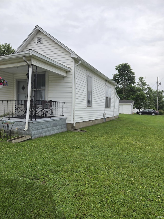 221 W 11th St, Bicknell, IN 47512 - view of home's exterior featuring a porch and a lawn