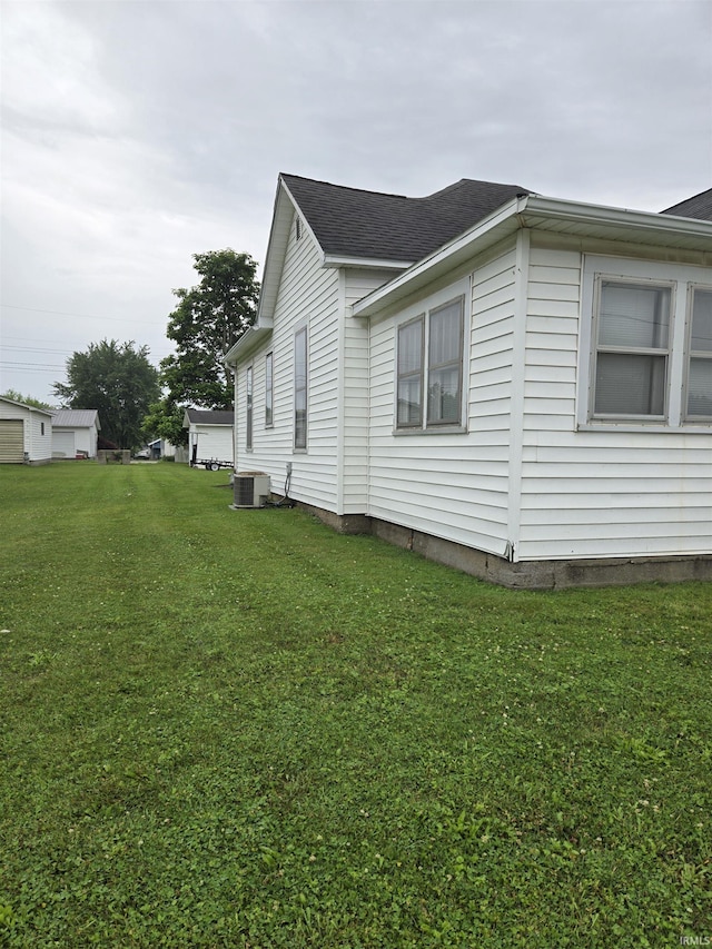 221 W 11th St, Bicknell, IN 47512 - view of side of home with a lawn and roof with shingles