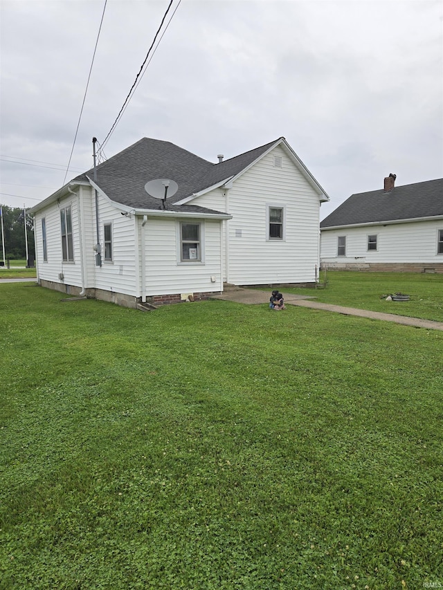 221 W 11th St, Bicknell, IN 47512 - rear view of property with a lawn and a shingled roof