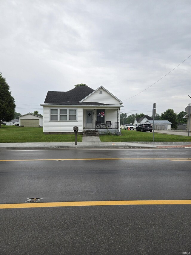 221 W 11th St, Bicknell, IN 47512 - view of front of property featuring a porch and a front lawn