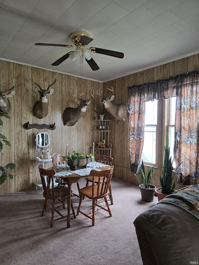 221 W 11th St, Bicknell, IN 47512 - carpeted dining area featuring wood walls and a ceiling fan