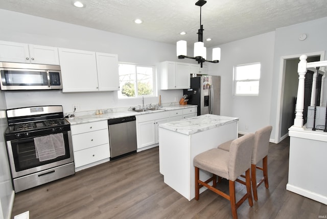 206 N Van Buren Ave, Fowler, IN 47944 - kitchen featuring stainless steel appliances, a kitchen island, white cabinetry, a textured ceiling, and recessed lighting