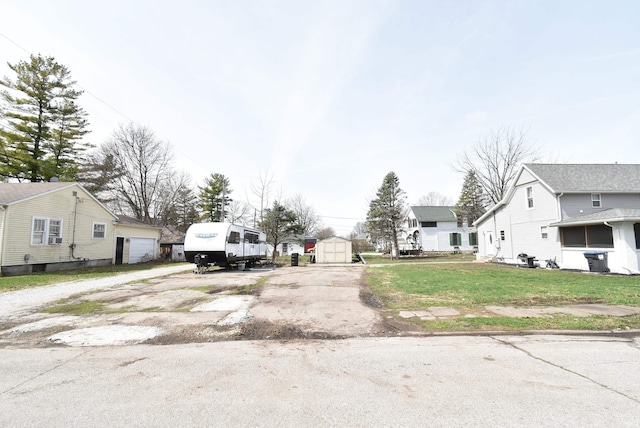 206 N Van Buren Ave, Fowler, IN 47944 - view of front of house featuring a storage unit, a residential view, and a front lawn