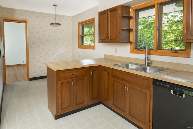 2330 N Fritz Dr, Bloomington, IN 47408 - kitchen with dishwasher, a peninsula, light countertops, brown cabinetry, and wallpapered walls