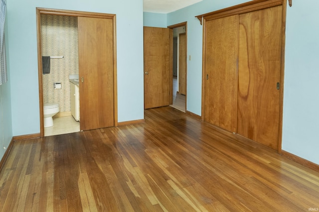 2330 N Fritz Dr, Bloomington, IN 47408 - unfurnished bedroom featuring wood finished floors, a closet, and connected bathroom