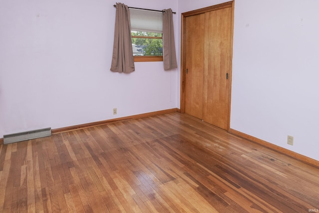 2330 N Fritz Dr, Bloomington, IN 47408 - spare room with hardwood / wood-style floors and a baseboard heating unit