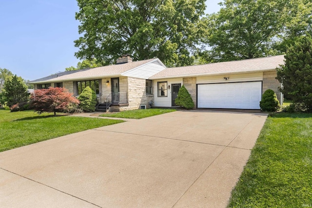 2330 N Fritz Dr, Bloomington, IN 47408 - view of front of home featuring stone siding, a garage, concrete driveway, a front yard, and a chimney