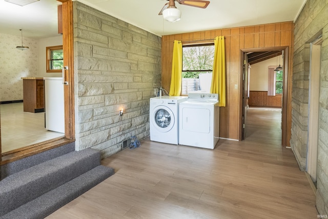 2330 N Fritz Dr, Bloomington, IN 47408 - laundry area featuring washing machine and dryer, ceiling fan, wood finished floors, and wooden walls