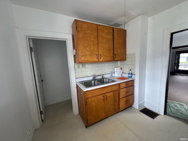 237 Stanley St, Mishawaka, IN 46545 - kitchen with light countertops, brown cabinetry, and backsplash