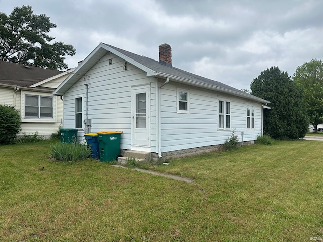 237 Stanley St, Mishawaka, IN 46545 - view of property exterior featuring a chimney and a yard