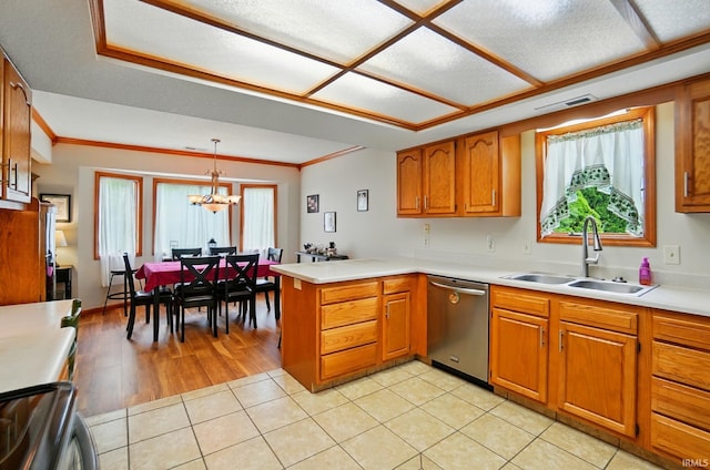 1322 Canal Ridge Dr, New Haven, IN 46774 - kitchen with stainless steel dishwasher, range, brown cabinetry, a peninsula, and healthy amount of natural light