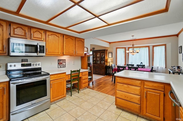 1322 Canal Ridge Dr, New Haven, IN 46774 - kitchen with stainless steel appliances, a chandelier, brown cabinets, light countertops, and crown molding