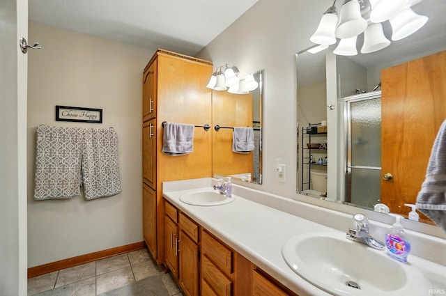 1322 Canal Ridge Dr, New Haven, IN 46774 - full bath featuring a shower stall, double vanity, tile patterned floors, and a chandelier