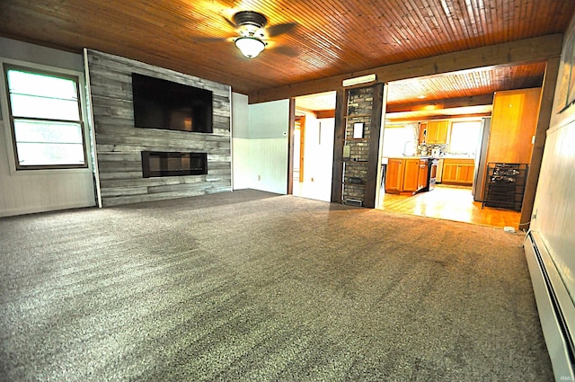 8077 E State Road 4th Rd, Walkerton, IN 46574 - unfurnished living room featuring baseboard heating, ceiling fan, a large fireplace, wood ceiling, and plenty of natural light