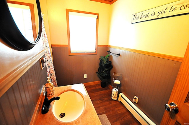 8077 E State Road 4th Rd, Walkerton, IN 46574 - bathroom with wainscoting, wood finished floors, a baseboard radiator, and vanity