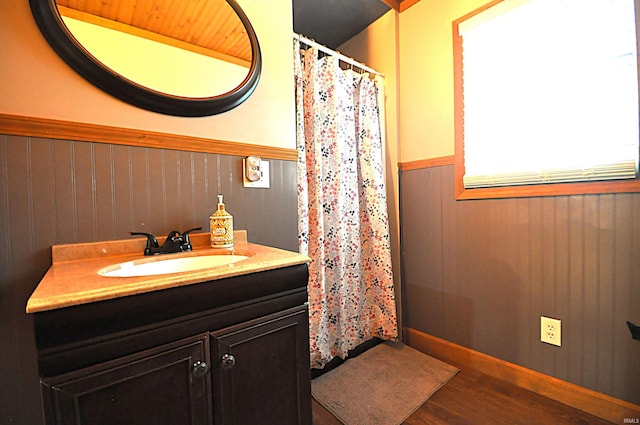 8077 E State Road 4th Rd, Walkerton, IN 46574 - full bathroom featuring vanity, wainscoting, wood finished floors, a shower with shower curtain, and wood walls
