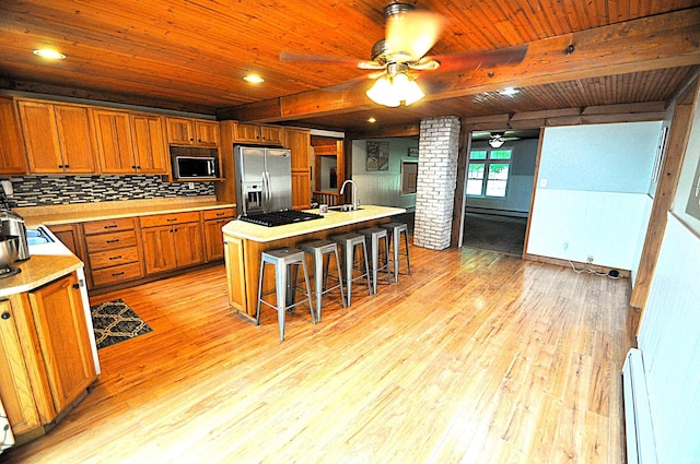 8077 E State Road 4th Rd, Walkerton, IN 46574 - kitchen featuring black appliances, baseboard heating, ceiling fan, light wood-type flooring, and light countertops