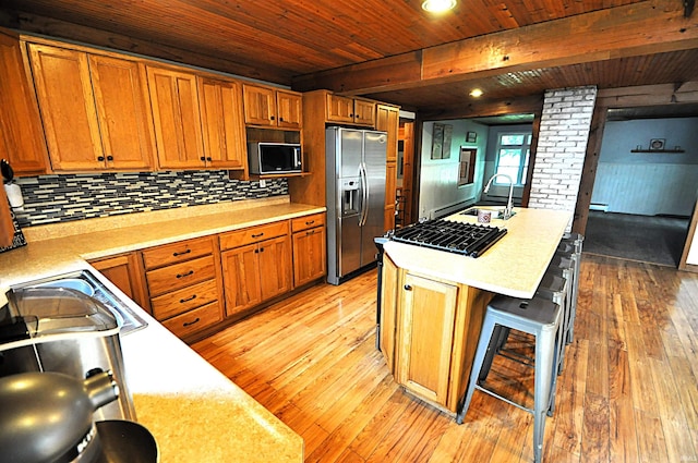 8077 E State Road 4th Rd, Walkerton, IN 46574 - kitchen with black appliances, light wood finished floors, light countertops, a wooden ceiling with exposed beams, and backsplash