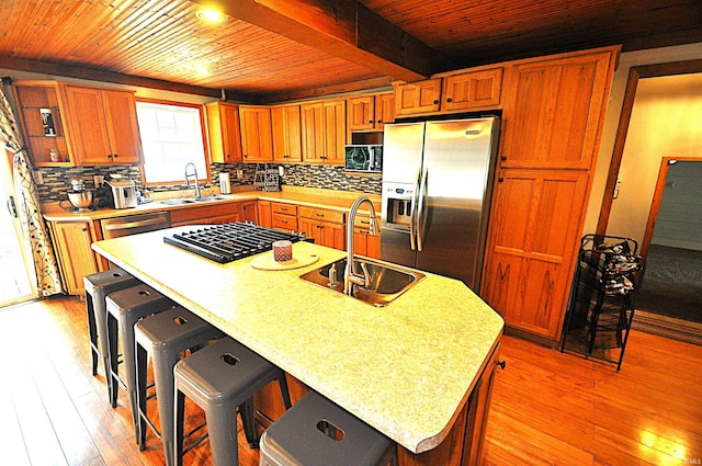 8077 E State Road 4th Rd, Walkerton, IN 46574 - kitchen with stainless steel appliances, a wooden ceiling with exposed beams, light countertops, light wood finished floors, and backsplash