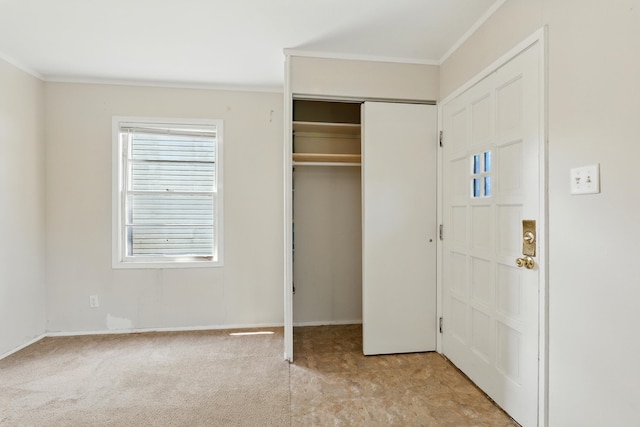 1610 Kentucky Ave, Fort Wayne, IN 46805 - unfurnished bedroom with ornamental molding, a closet, and light carpet