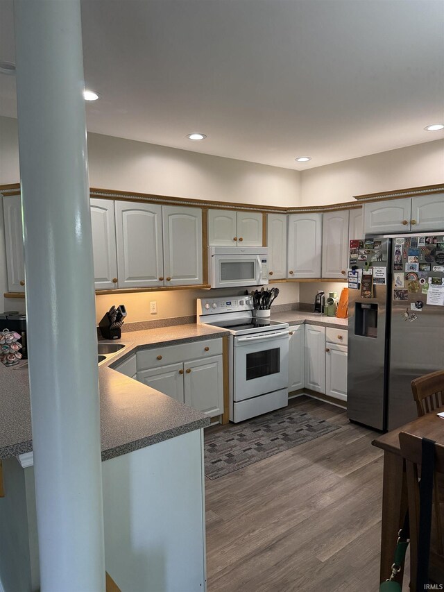 5844 Flagstone Dr, Evansville, IN 47711 - kitchen featuring white appliances, dark wood-style floors, recessed lighting, and ornate columns