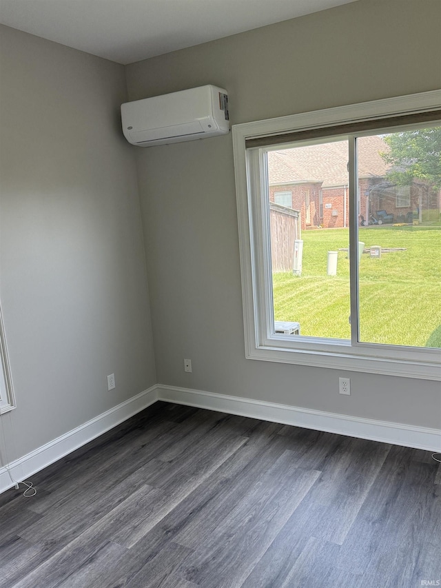 5844 Flagstone Dr, Evansville, IN 47711 - spare room with a wall unit AC and dark wood-type flooring